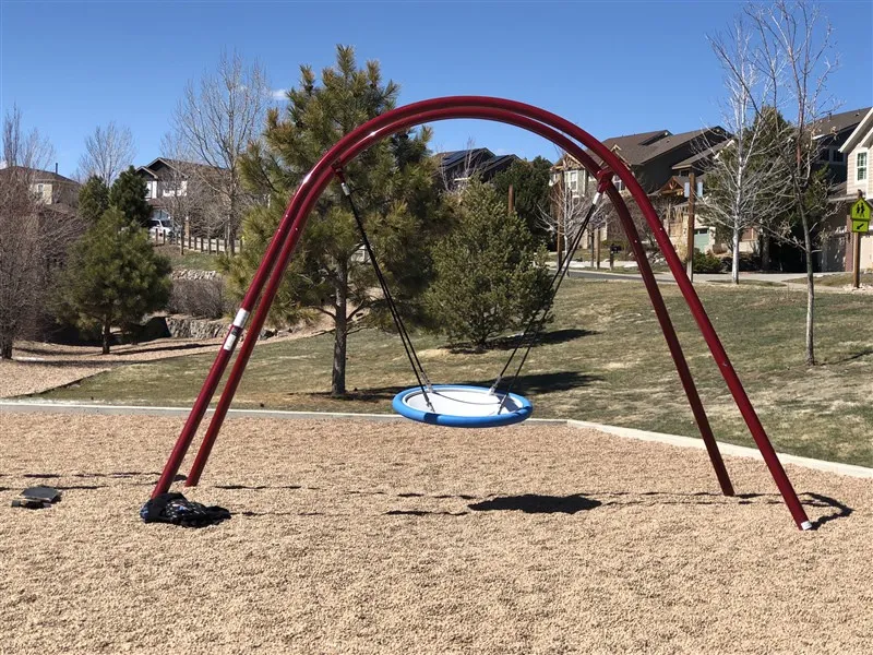 Round single playground swing at Black Forest Elementary School